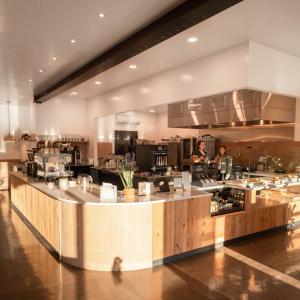 a large kitchen with two people standing in the kitchen at Summit Lofts Boutique Hotel in Mount Shasta