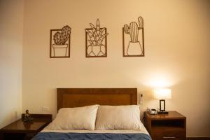 a bedroom with a bed and three pictures on the wall at Estancia 102 in La Paz