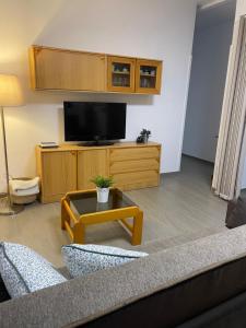 a living room with a couch and a flat screen tv at Apartamento RODA - Candelaria in Candelaria