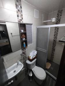 a bathroom with a toilet and a shower and a sink at Hospedaje Estrella de Luna in Bogotá