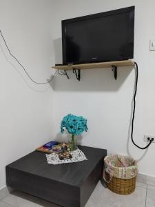 a flat screen tv on a wall with a table at Hospedaje Estrella de Luna in Bogotá