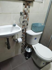 a bathroom with a toilet and a sink at Hospedaje Estrella de Luna in Bogotá