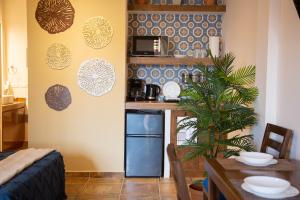 a kitchen with a table and a dining room at Estancia 105 in La Paz +3 photos