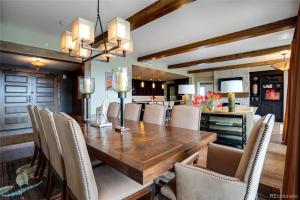 a dining room with a wooden table and chairs at Edgemont 2301 Luxury Condo with Backdoor Ski-In Ski-Out Access! in Steamboat Springs