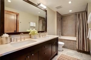 a bathroom with a sink and a toilet and a mirror at Edgemont 2301 Luxury Condo with Backdoor Ski-In Ski-Out Access! in Steamboat Springs +9 photos