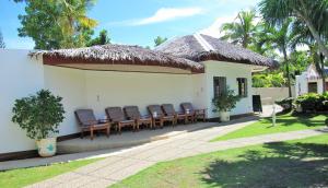a group of chairs sitting on the outside of a house at Quo Vadis Dive Resort in Moalboal