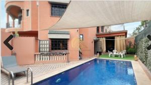 a house with a swimming pool next to a building at Authentic Targa Villa with a Private Pool No overlooking in Marrakech