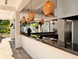 a kitchen with a counter with pendant lights at CASA VACACIONAL CAMPOSOL in Melgar
