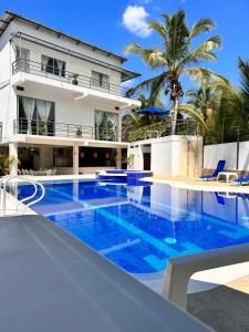a pool in front of a house with blue water at CASA VACACIONAL CAMPOSOL in Melgar