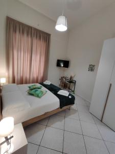 a bedroom with a bed and a television in it at Nalusa Home in Sarno