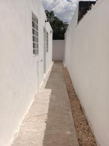 an alleyway between two white buildings at Casa de 3 recamaras frente al parque in Mérida