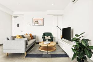 a living room with a couch and a coffee table at Modern 2BD in Trendy Inner West in Sydney