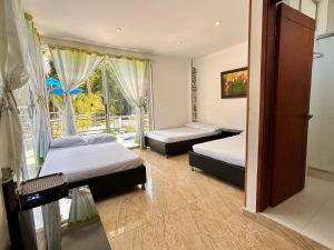 - une chambre avec 2 lits et une fenêtre avec vue dans l'établissement CASA VACACIONAL CAMPOSOL, à Melgar
