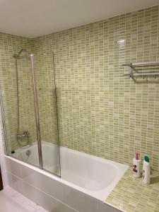 a bathroom with a shower and a bath tub at Acogedor apartamento ático en el centro de O Porriño in Porriño