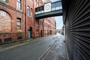an empty city street with a clock on a building at The calm apartment with 2 ensuite bedrooms. in Preston