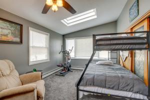 a bedroom with a bunk bed and a ceiling fan at Spacious Sheboygan Home with Grill and Fire Pit! in Sheboygan