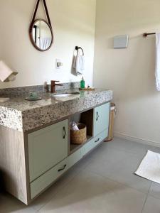 a bathroom with a sink and a mirror at Lake House_SC in Rio Forcação +33 photos