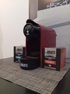 a coffee maker and two boxes on a table at GreenHouse in Casale Smeraldi