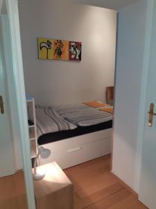 a small bed in a room with at Apartment Dahlia Vienna in Vienna