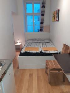 a small bedroom with a bed and a window at Apartment Dahlia Vienna in Vienna