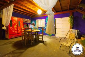 a dining area with a table and chairs in a house at Pousada Cantos do Cerrado in Chapada dos Guimarães