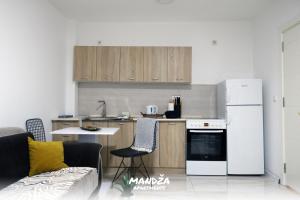 a kitchen with a white refrigerator and a table at Mandza in Novi Pazar