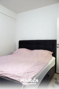 a bed in a room with a pink mattress at Mandza in Novi Pazar