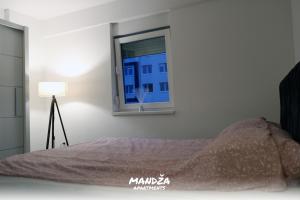 a bedroom with a bed and a window at Mandza in Novi Pazar