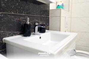 a bathroom sink with a faucet on top of it at Mandza in Novi Pazar