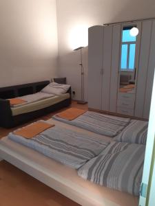 two beds in a room with a mirror at Apartment Dahlia Vienna in Vienna