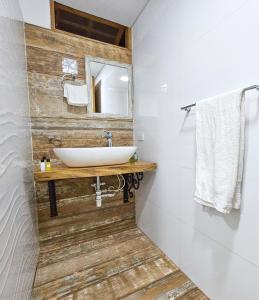 a bathroom with a sink and a mirror at La Mercedes Boutique Hostal By MH in Cali