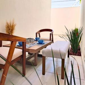 a dining room with a wooden table and chairs at Costa Azul SunnyAdventureTravel in La Paz