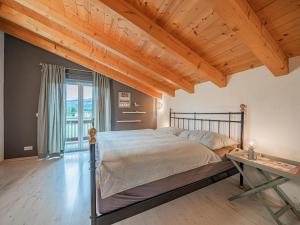 a bedroom with a bed and a wooden ceiling at Panoramahaus Itter in Itter