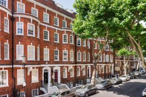 a red brick building with cars parked in front of it at Small studio in Central London Pay Straight Away to the host in London