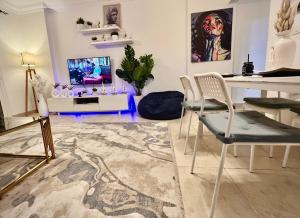 a living room with a table and chairs and a television at Madinaty in Madinaty