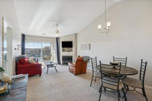 uma sala de estar com mesa e cadeiras em Lake Ozark Condo with Screened Balcony and Lake Views! em Lake Ozark