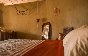 a bedroom with a bed in a room at Bambuddha - Garden Suite at Lakehouse in San Pedro La Laguna