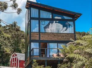 a house with a large window on the side of it at Cabanas Urubici in Urubici