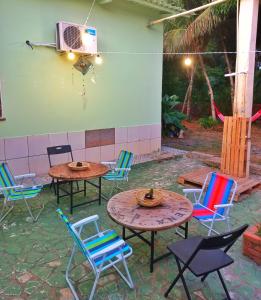 Aquiri Hostel في ريو برانكو: فناء به طاولات وكراسي في ساحة