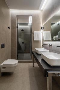a bathroom with a toilet and a sink and a shower at ICONIC SALONICA SUITE seafront in Thessaloniki
