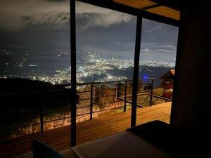 a room with a view of a city at night at Se Alquila Hermosa Cabaña Turquesa in Lebrija
