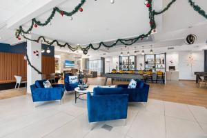 a living room with blue furniture and christmas decorations at Urban Elegance: 20 Minutes to NYC (Gym, Laundry) in Jersey City