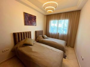 a bedroom with two beds and a window at Rabat, Hassan Downtown: Tramway, sunshine, privacy in Rabat