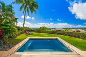 a swimming pool in the backyard of a villa at 2 BR Luxury Oceanview Condo in Kukuiula in Koloa