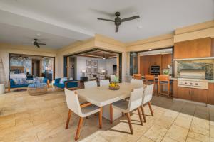 a kitchen and living room with a table and chairs at 2 BR Luxury Oceanview Condo in Kukuiula in Koloa