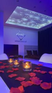 a room with candles and red petals on the floor at MP Apartament Białystok Jacuzzi in Białystok