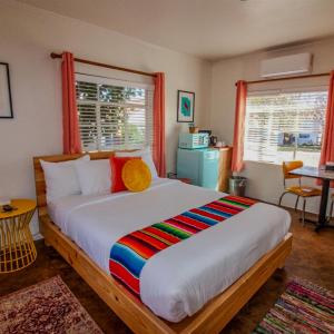a bedroom with a large bed with a colorful blanket at Antelope Lodge in Alpine