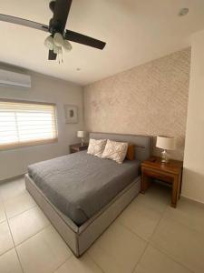 1 dormitorio con 1 cama y ventilador de techo en Casa Completa con Alberca privada en La Paz