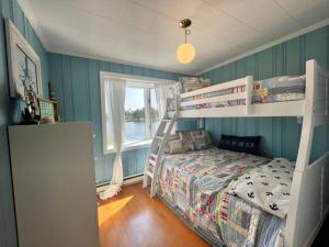 a bedroom with two bunk beds and a window at Salt Pond Sunrise View & 5 min to beach, sleeps 7 in Charlestown