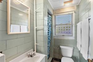 a bathroom with a sink and a toilet and a tub at Salt Pond Sunrise View & 5 min to beach, sleeps 7 in Charlestown